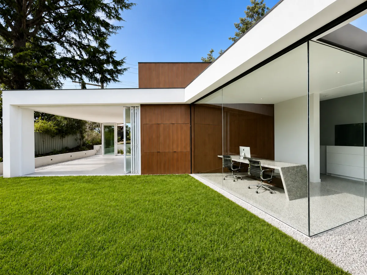 Completed home by Ottimo Homes with glass walled study, timber cladding and landscaped lawn, Canberra
