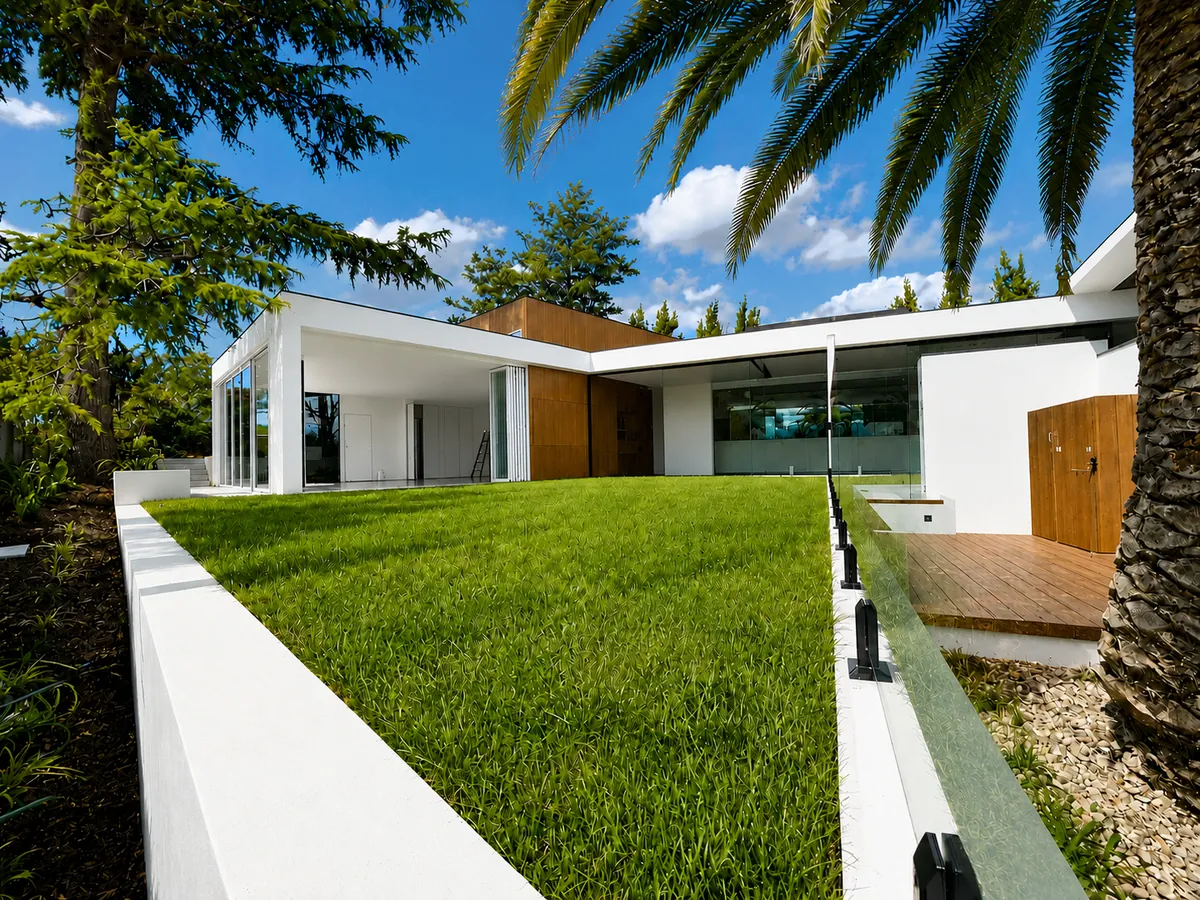 Front approach to the home with white render, timber entry and lawn, Weston