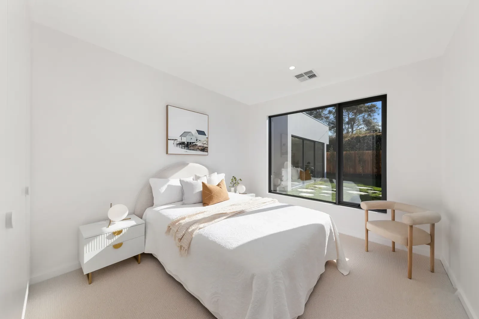 Styled secondary bedroom with courtyard window